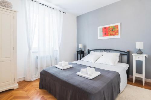 a bedroom with a bed with two towels on it at M&A Apartments in Zadar