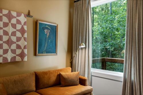 a living room with a couch and a window at Roamstead Smoky Mountains in Cosby