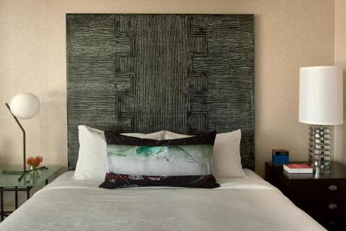 a bedroom with a bed with a large headboard at Kimpton Hotel Palomar Los Angeles Beverly Hills by IHG in Los Angeles