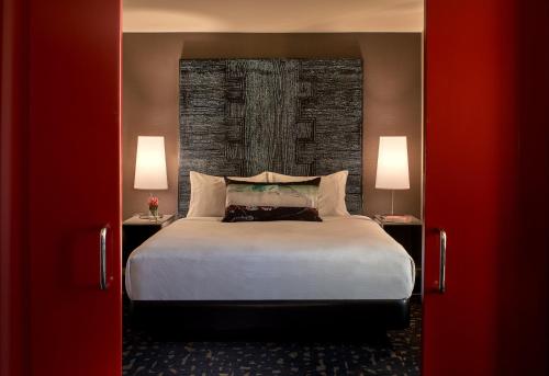 a bedroom with a large bed and two lamps at Kimpton Hotel Palomar Los Angeles Beverly Hills by IHG in Los Angeles