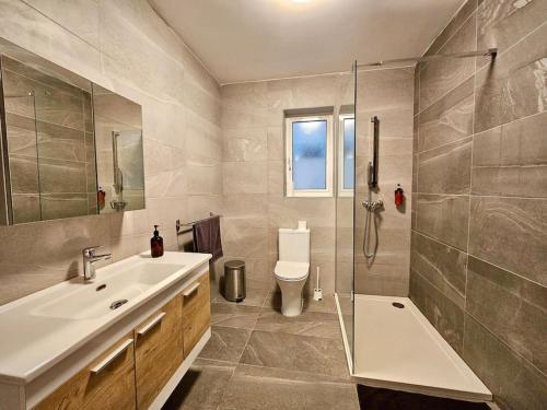 a bathroom with a sink and a toilet and a shower at Sleeps 6 Spacious Apartment St Pauls Bay in St. Paul's Bay