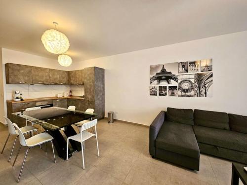 a living room with a couch and a table at Sleeps 6 Spacious Apartment St Pauls Bay in St. Paul's Bay