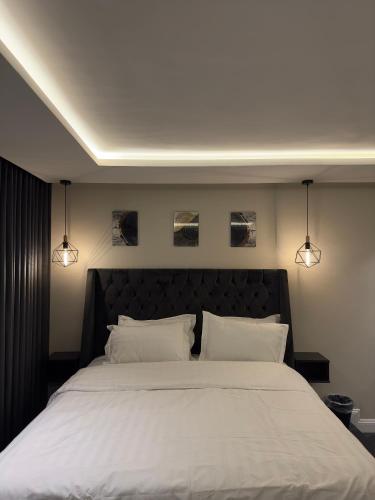 een slaapkamer met een groot bed met 2 witte kussens bij أجنحة لافينا الخاصة in Yanbu