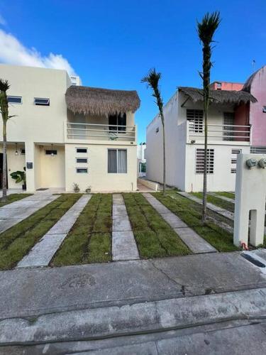 プエルト・モレロスにあるCasa Pelicanoの前にヤシの木がある家