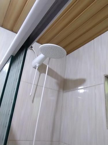 a light hanging from the ceiling of a bathroom at Casa Maria Rosa in Blumenau