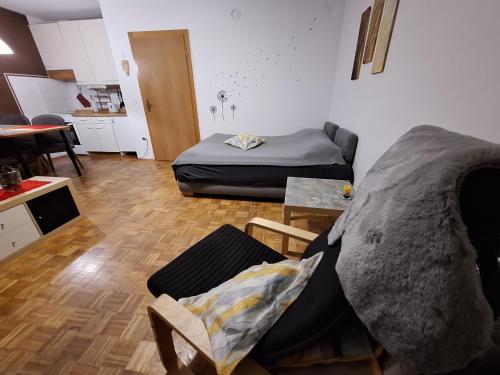 a living room with a bed and a couch at Apartment San Izola - near the beach in Izola