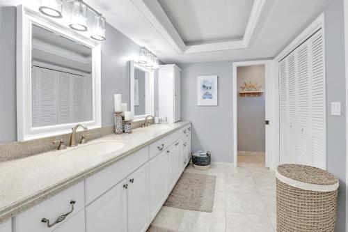 a bathroom with two sinks and a large mirror at Family Friendly Fort Myers Vacation Rental with Pool in Fort Myers