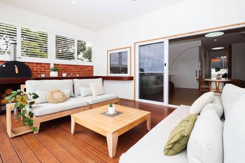 a living room with a white couch and a table at Palm Springs in Port Lincoln! in Port Lincoln