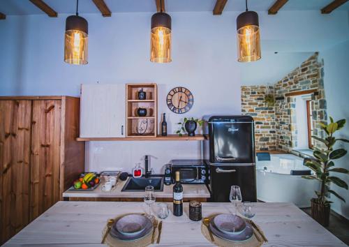 a kitchen with a table with two plates on it at SELO Luxury Suite in Álli Meriá