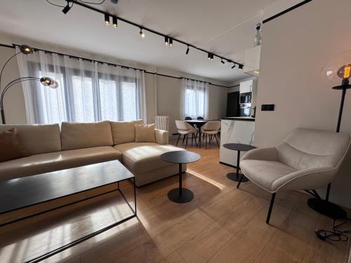 un soggiorno con divano e tavolo di Appartement Hyper-Centre Megeve - ski à pied a Megève