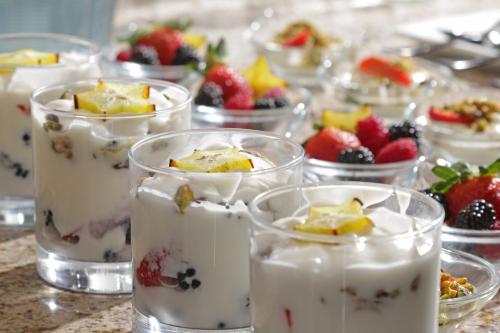a group of glasses filled with desserts and fruit at voco Saltillo Suites by IHG in Saltillo