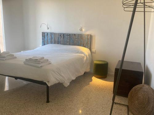 a bedroom with a bed with a wooden headboard at La Casa nell'Orto in Fermo