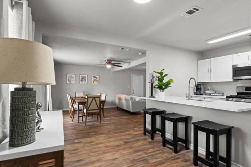 a kitchen and living room with a table and chairs at Steps to Lackland AFB & SeaWorld in San Antonio