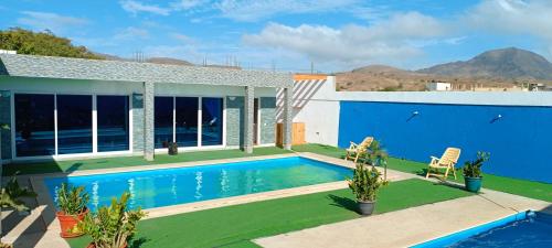 a villa with a swimming pool and a house at Residência Águia in Praia