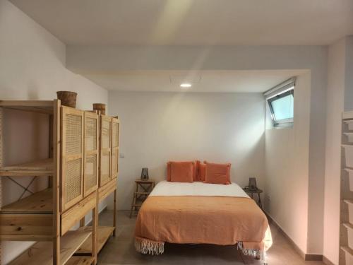 a bedroom with a bed with orange pillows on it at Romantic Studio in Vila do Conde