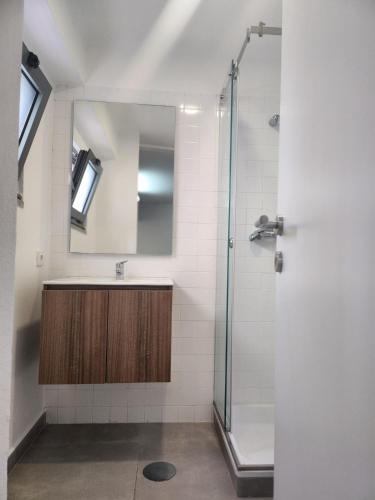 a bathroom with a shower and a sink and a mirror at Romantic Studio in Vila do Conde