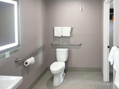 a bathroom with a toilet and a sink and towels at Motel 6-Morro Bay, CA in Morro Bay