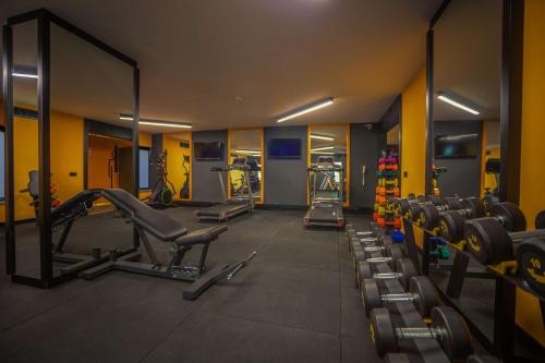 a gym with a row of chairs and a mirror at Best Western Plus Khan Hotel in Antalya