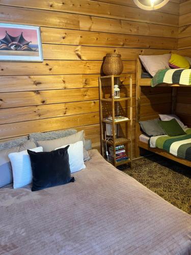 a bedroom with two beds in a log cabin at Augļu ielas pirts māja in Jūrmala