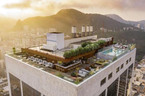 a building with a pool on top of it at Hilton Copacabana Rio de Janeiro in Rio de Janeiro