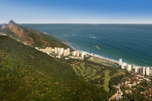 a kite flying over the ocean next to a city at Hilton Copacabana Rio de Janeiro in Rio de Janeiro