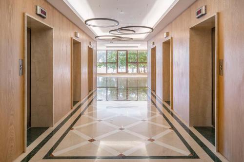 a hallway with a tile floor and a large window at Hilton Copacabana Rio de Janeiro in Rio de Janeiro