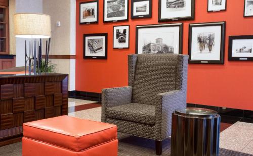 a room with a chair and pictures on the wall at Drury Inn & Suites Columbus Grove City in Grove City
