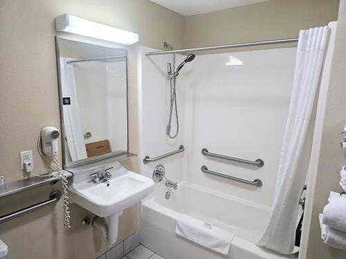 a white bathroom with a sink and a shower at Baymont by Wyndham Rolla in Rolla