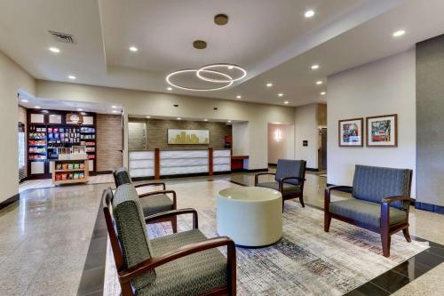 a waiting room at a hospital with chairs and a table at Drury Inn & Suites Orlando near Universal Orlando Resort in Orlando