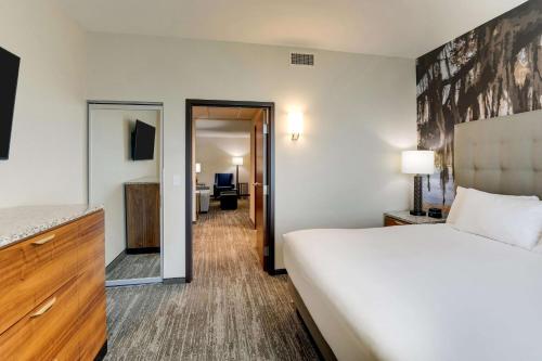 a hotel room with a bed and a bathroom at Drury Plaza Hotel Tallahassee in Tallahassee