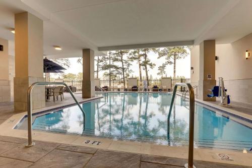a swimming pool at a hotel with blue water at Drury Plaza Hotel Tallahassee in Tallahassee