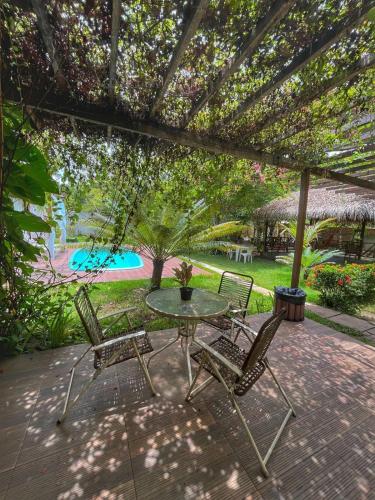 a patio with a table and two chairs on a patio at Casa de Férias em Alter do Chão-PA in Alter do Chao