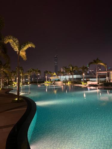 a large swimming pool with palm trees at night at Skyscraper 65 KL Highest Outdoor Bathtub Luxury Lavish Designer Penthouse in Kuala Lumpur