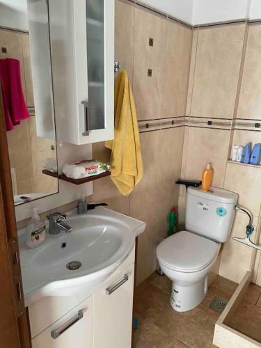 a small bathroom with a sink and a toilet at House by the beach,next to village,sunset view in Finikas