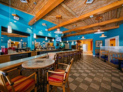 a restaurant with a bar with wooden ceilings at Holiday Inn Club Vacations Cape Canaveral Beach Resort in Cape Canaveral