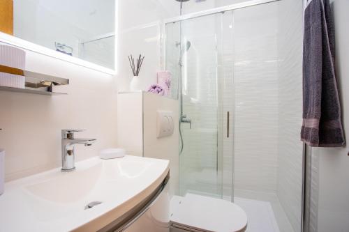 a bathroom with a shower and a toilet and a sink at Apartment Duce 2778b in Duće
