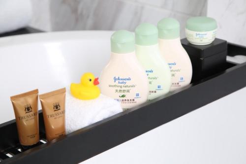 a shelf with bottles of milk and a rubber duck at Marco Polo Xiamen in Xiamen