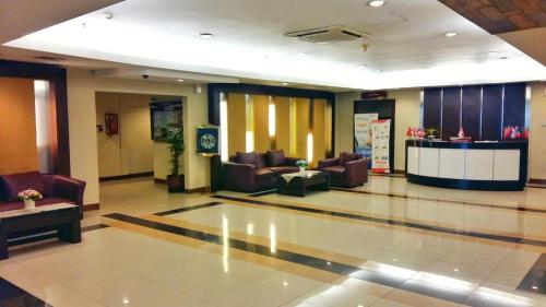 a lobby with couches and chairs in a building at Apartment Thamrin City mall 3 BR near Tanah abang in Jakarta