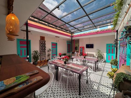 a dining room with tables and chairs and a glass ceiling at CASA HOTEL LAS HORTENSIAS in Jardin