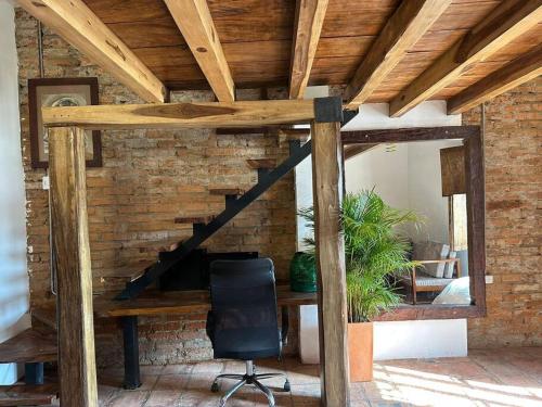 a staircase in a room with a desk and a chair at AptoPardo1945 in Mompos