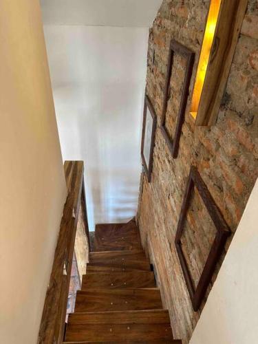 a staircase with two pictures on a brick wall at AptoPardo1945 in Mompos