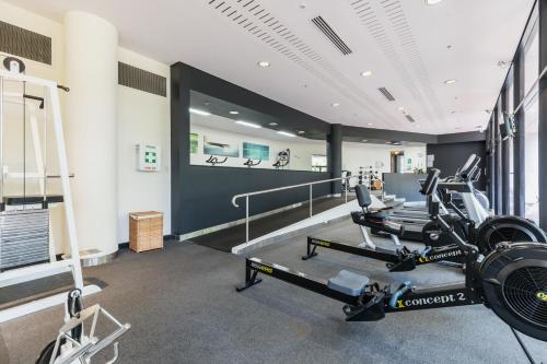 a gym with treadmills and ellipticals in a room at Crowne Plaza Canberra by IHG in Canberra