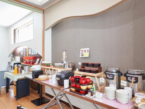 a kitchen with a table with food on it at Hotel Yamanouchi in Naha