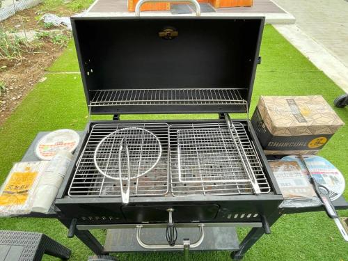 a grill with a racket and boxes on the grass at Issyuku Ike Issyo En - Vacation STAY 86605v in Tabuchi