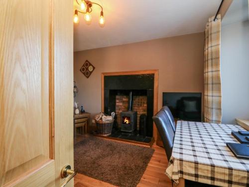 a dining room with a table and a fireplace at Marys House in Kilchoan