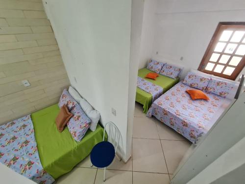 a room with two beds and a window at POUSADA DO HOSTEL in Jacobina