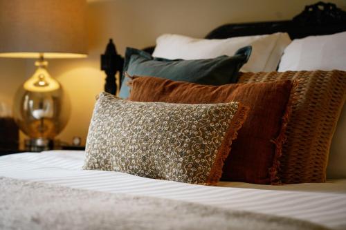 a bed with several pillows on top of it at Barossa Bed & Breakfast in Tanunda
