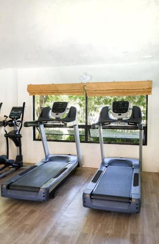 a gym with two exercise bikes and a window at Bluewater Maribago Beach Resort in Mactan