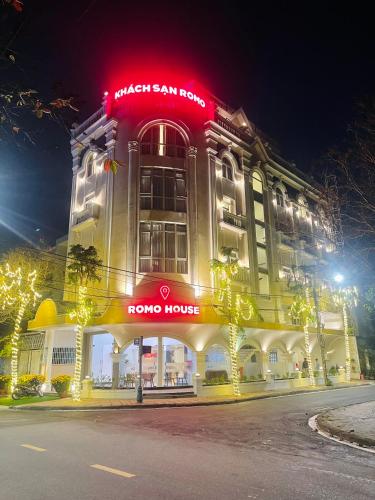 a building with a red sign on top of it at KHÁCH SẠN ROMO in Quang Ngai