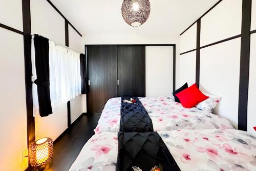 um quarto com uma cama grande e almofadas vermelhas em OPEN SALE-Full renovation-stations 4 min-USJ& Namba nearby em Osaka